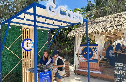 Staff assisting a customer at a GCash booth in Boracay.
