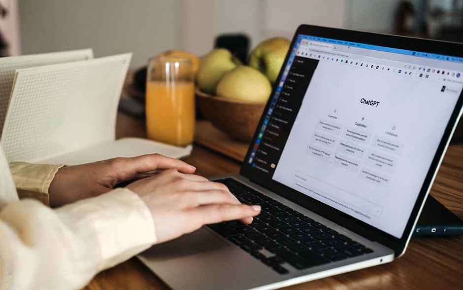 A close-up of female hands typing on a laptop, with a screen displaying ChatGPT for content creation, showing AI-generated ideas and content.