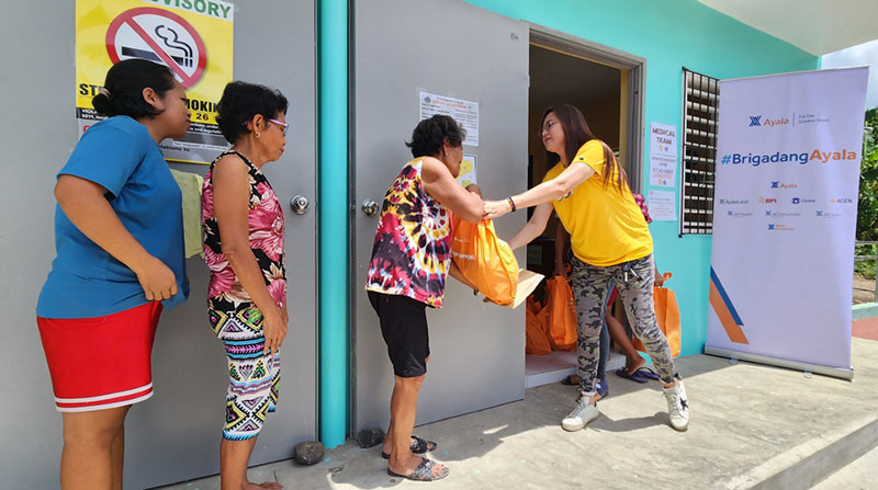 A volunteer distributes relief packs to evacuees affected by Mayon Volcano unrest in Albay.