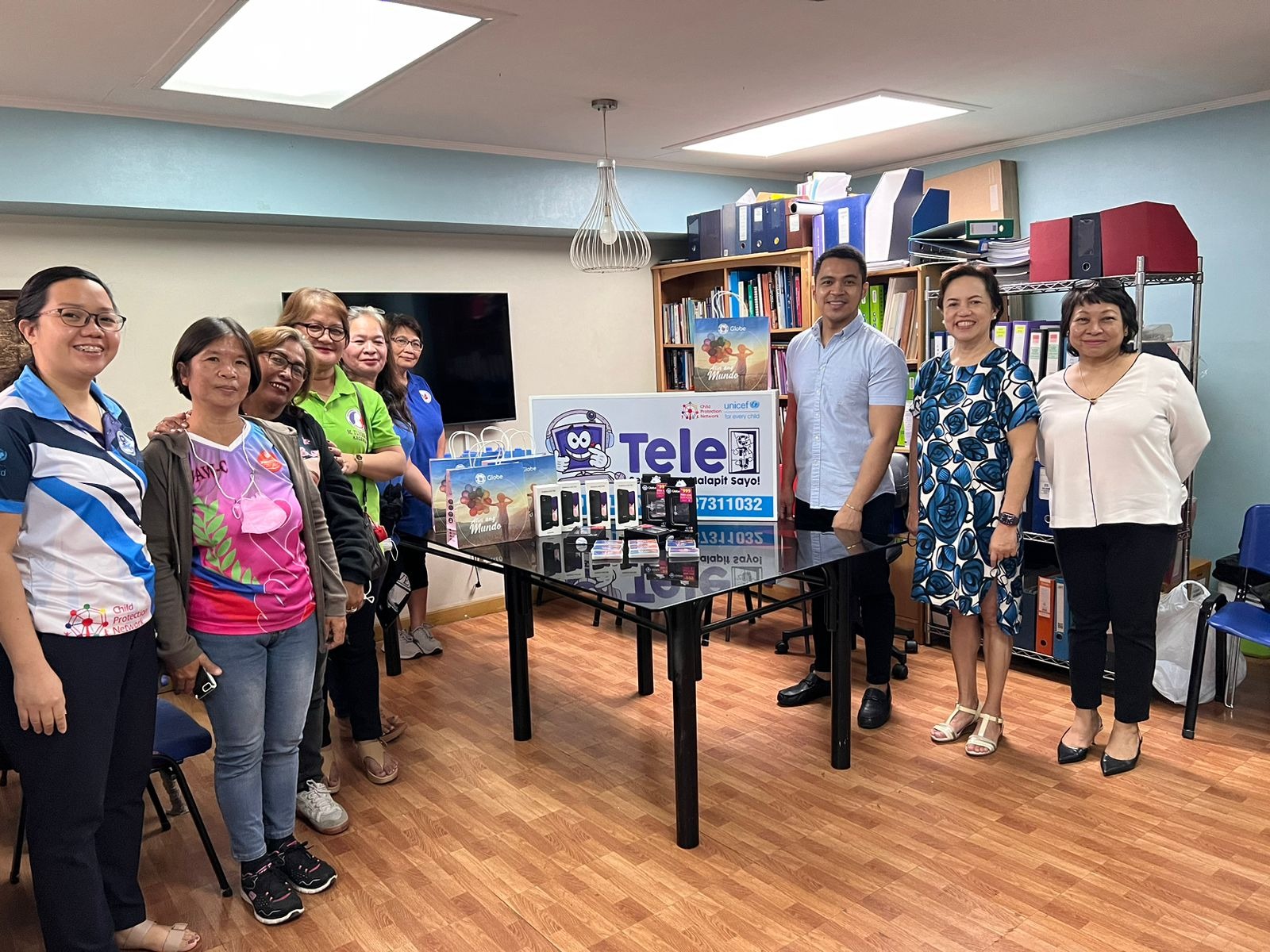 Globe, CPN, and UNICEF representatives with local VAWC officers at the TeleCPU Center sa Barangay project launch.