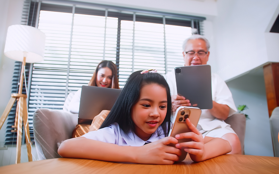 A multi-generational family using their digital devices in the living room.
