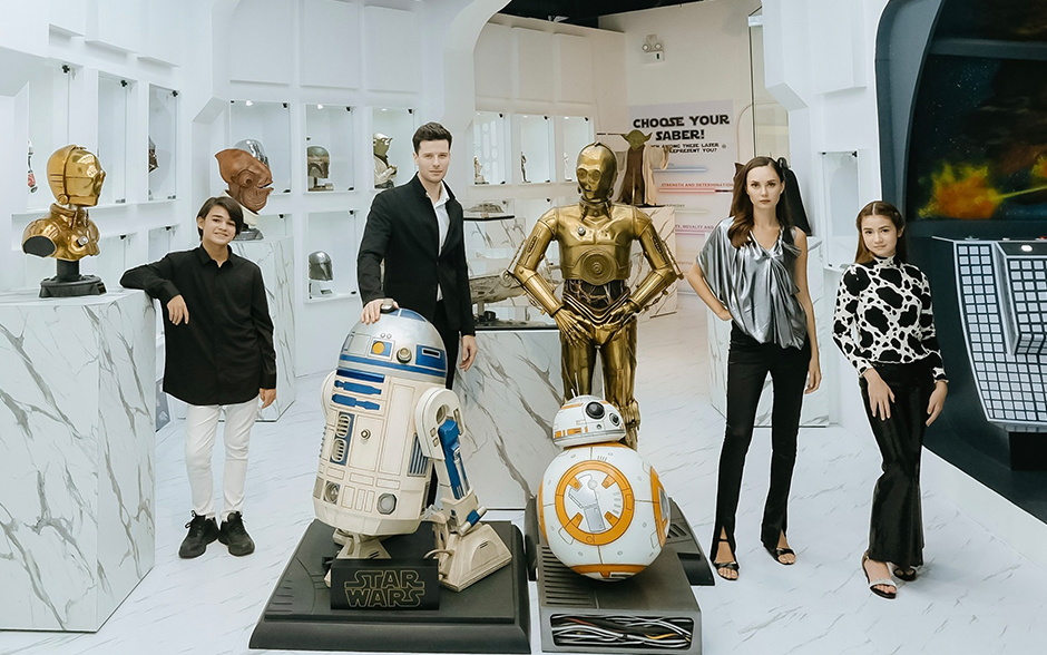 Photo of models posing with the Star Wars collection at the Omniverse Museum.
