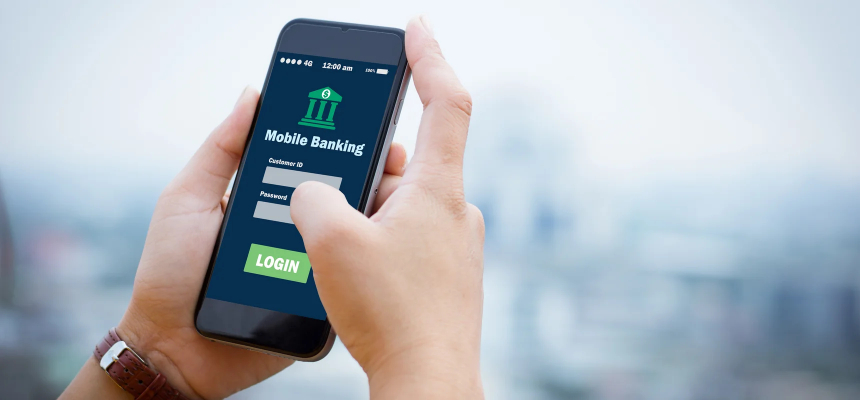 Hands holding a smartphone with a digital bank app.