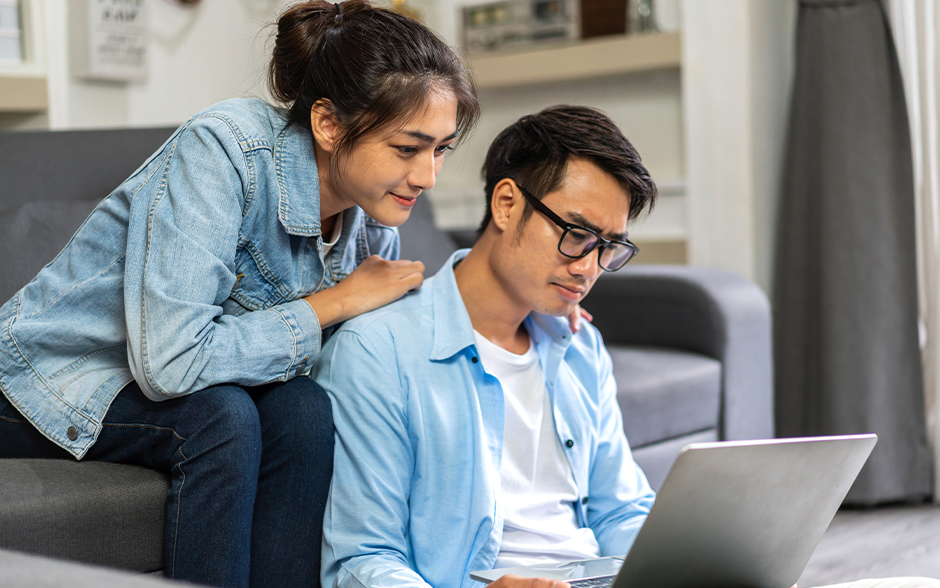 Young Asian couple review Japanese visa requirements.