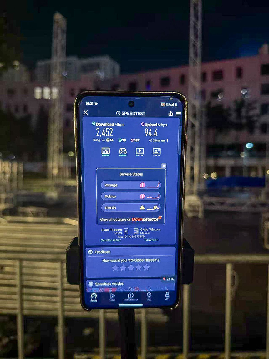 A smartphone using Ookla Speedtest to test the speed of mobile data at an amphitheater.