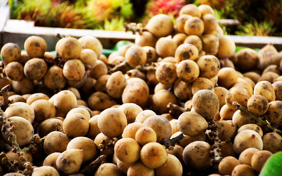 Lanzones for sale on a table.