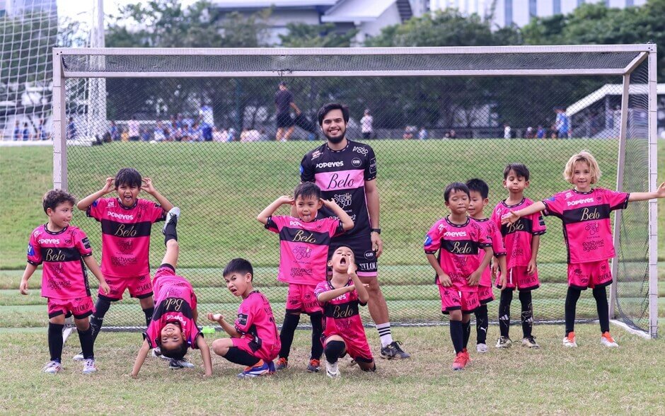 Group of kids in pink football jerseys and shorts from G8 Academy.