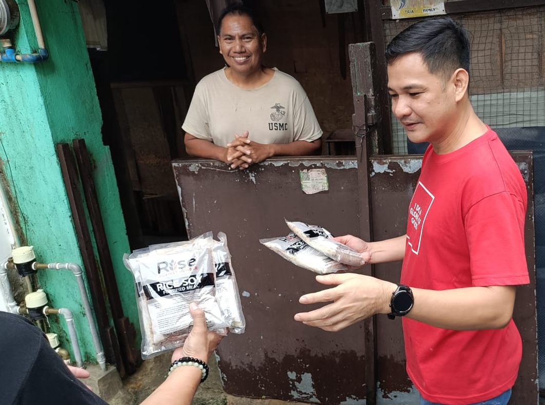 Globe distributing food packs to families affected by typhoons.