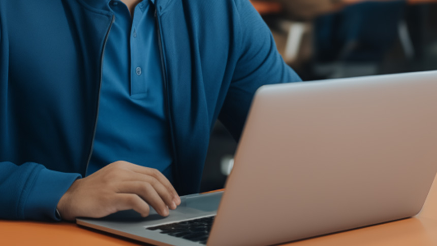 A man using his laptop at an office.