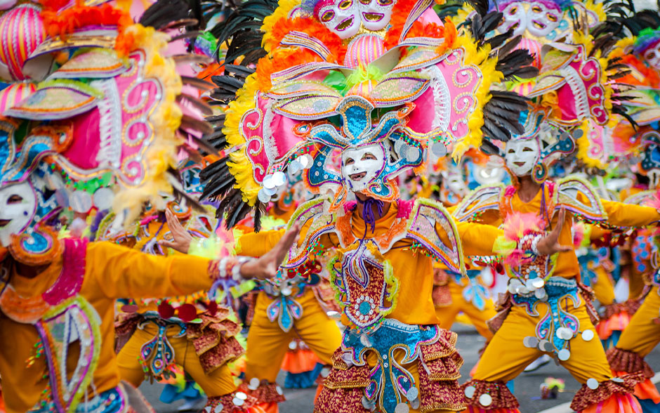 MassKara dancers in colorful costumes and masks.