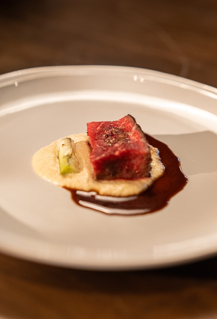 Chef Kevinâs black onyx striploin with soubise and porcini.