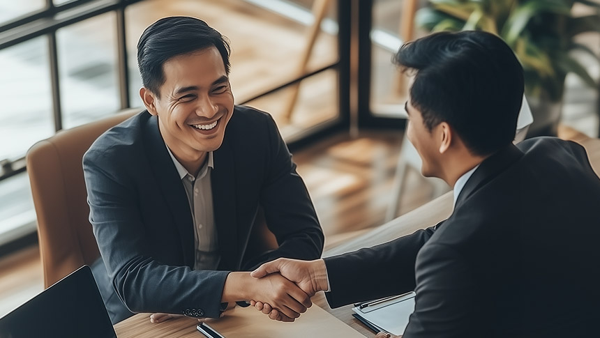 Two male professionals shaking hands.