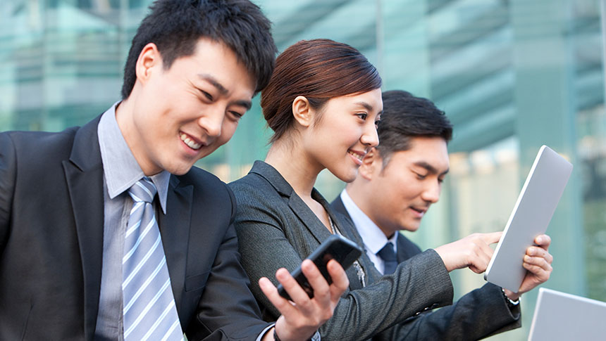 A group of professionals using their gadgets for work.