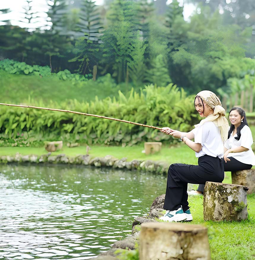 Two women fishing by a pond in a green park.