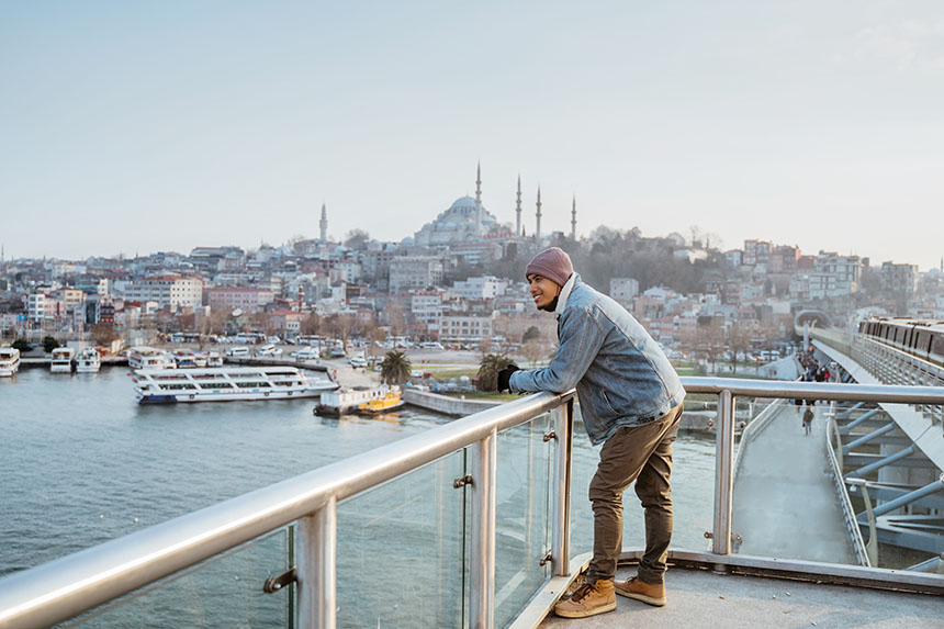 A male traveler sightseeing at an international port area.