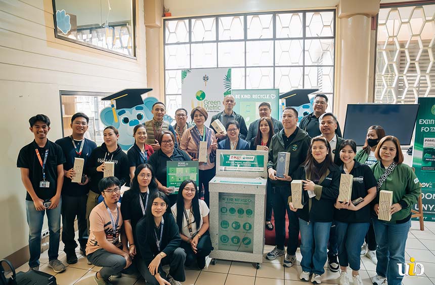 Students and faculty pose during a campus recycling and sustainability event.