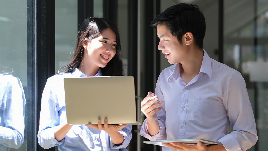 A male and female professional working together at the office