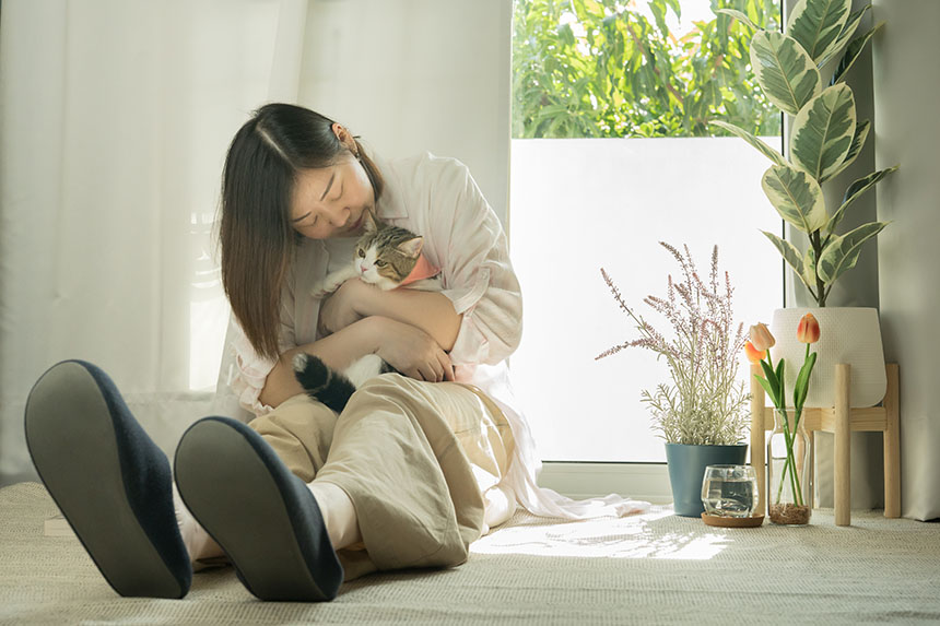 A female pet owner showing affection to her dog.