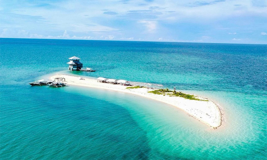Aerial view of the Carbin Reef, its scenic sandbar stretching against the backdrop of the open sea.