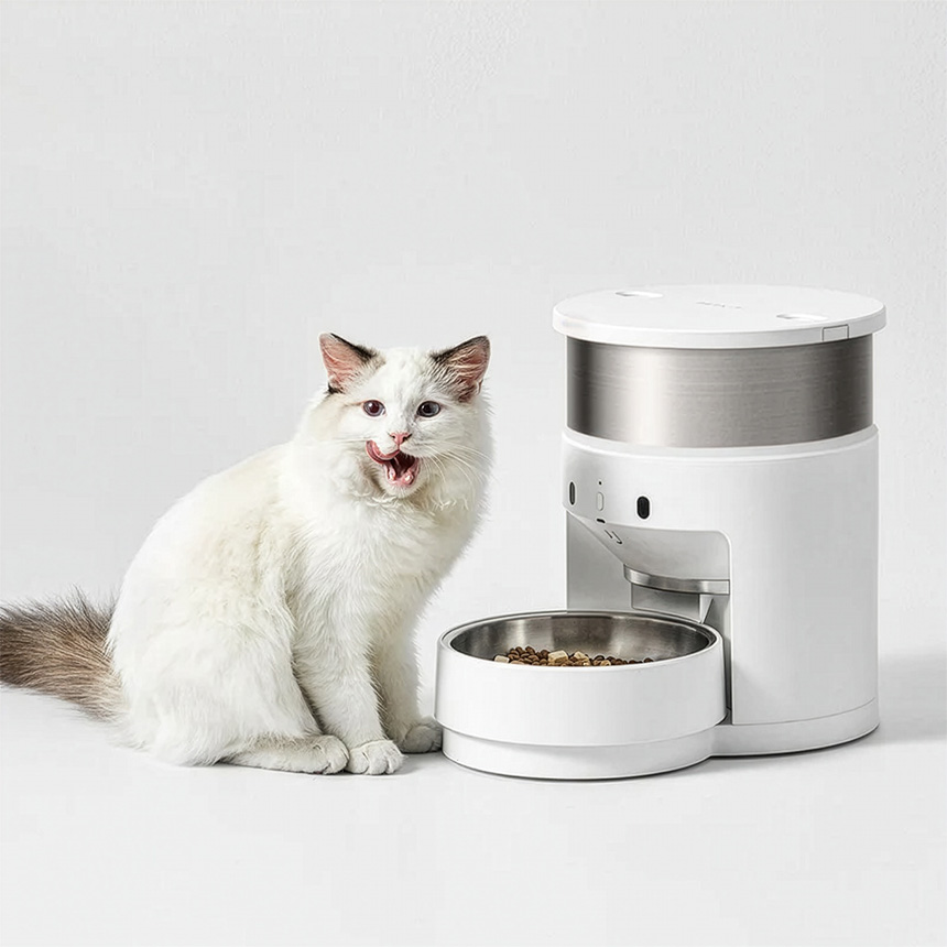 White cat sitting beside the PETKIT Fresh Element Gen 3 smart pet feeder with stainless steel bowl.