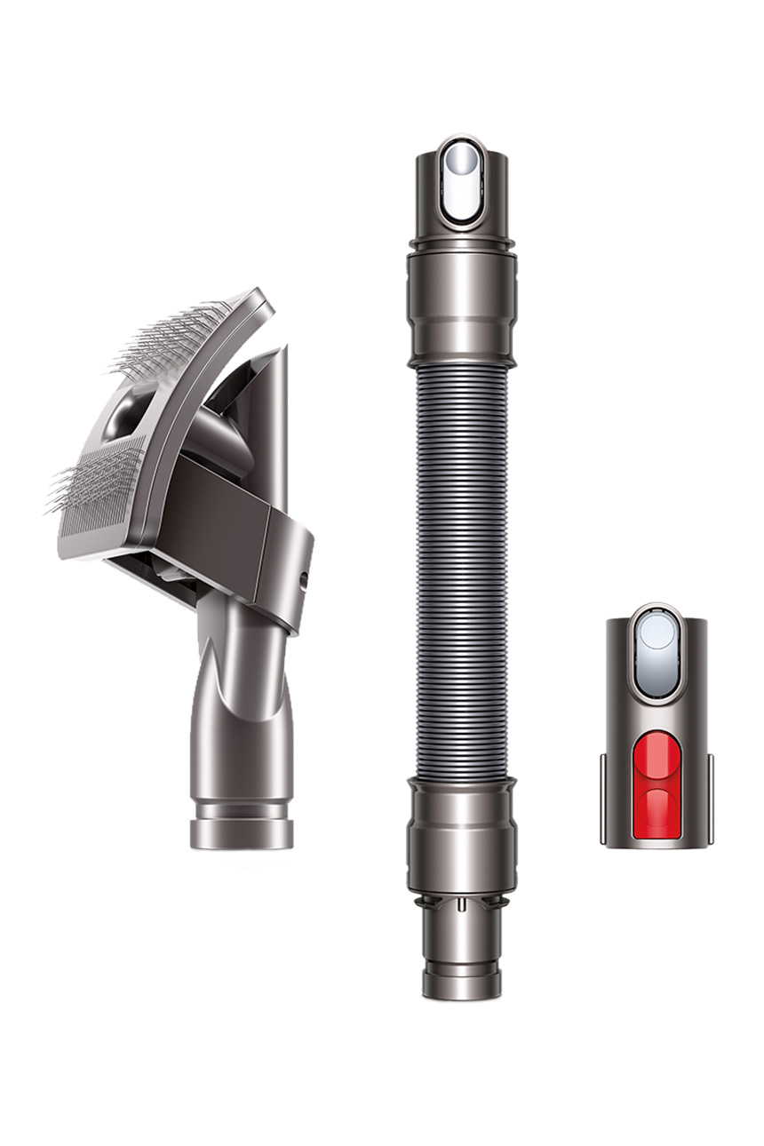 Dyson pet grooming attachment with flexible brush head and vacuum hose components.