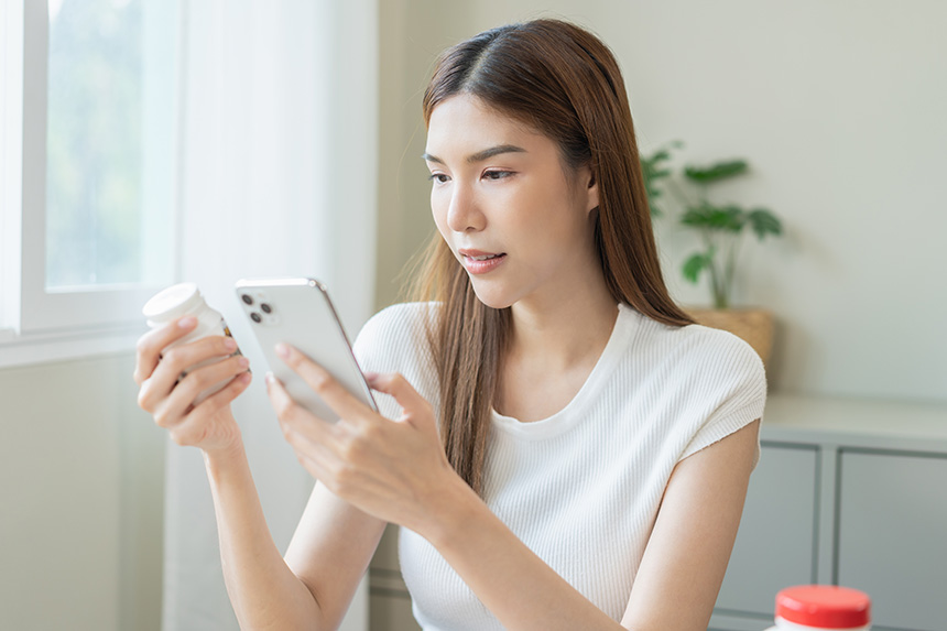 Woman looking at her mobile device for medical information to prepare for emergencies.
