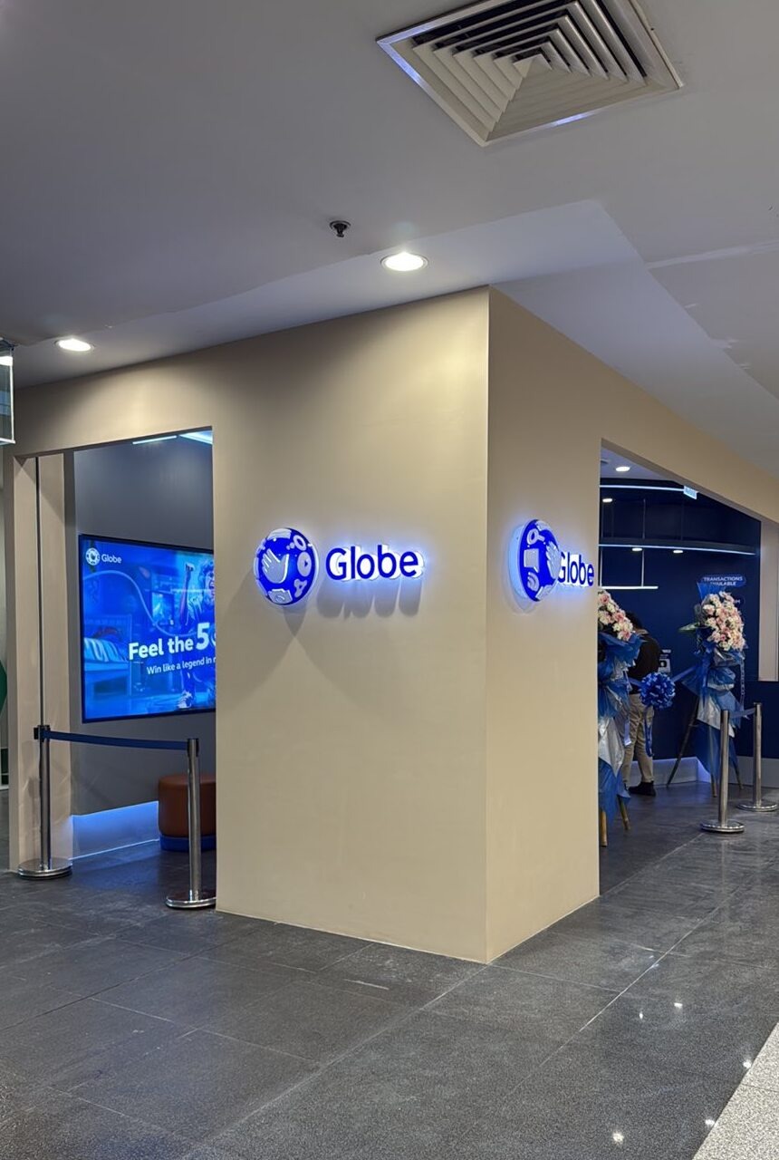Corner view of the Globe store at NAIA Terminal 3 arrivals, decorated with blue and white flower stands for the opening.