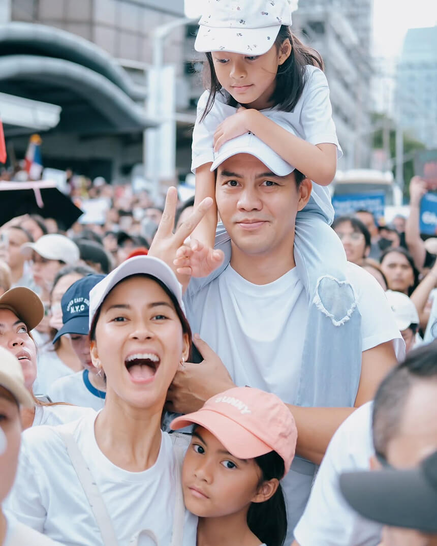 Bianca Gonzalez with her husband and children at a crowded outdoor event.