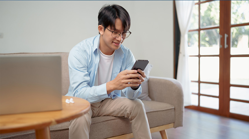 Man engaged with his mobile device, lounging in a stylish living room.