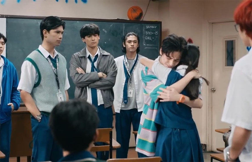 Ci-N and Jayjay share a warm hug as other Section E students gather around them.