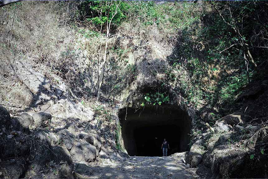 Entrance of Pamitinan Cave in Rizal surrounded by rocks and trees