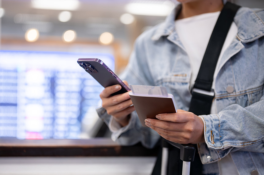 A passenger checking her flight details on her phone.