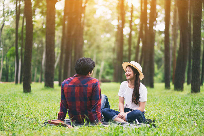 Young Asian couple on a date at a park.