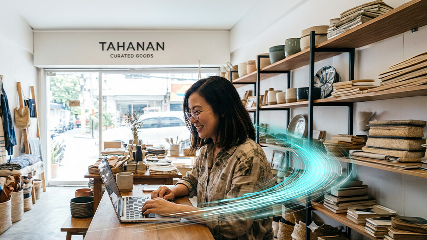 A woman using a laptop at Tahanan Curated Goods store.