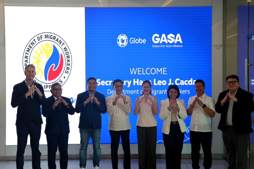 Globe, DMW, and GASA officials pose together to launch an anti-scam partnership for OFW protection.