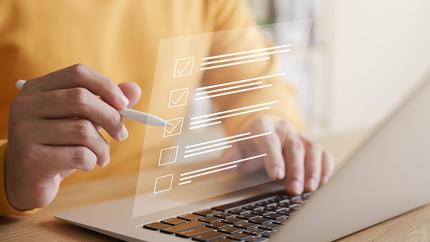 A person completing an online checklist for business registration on a laptop.