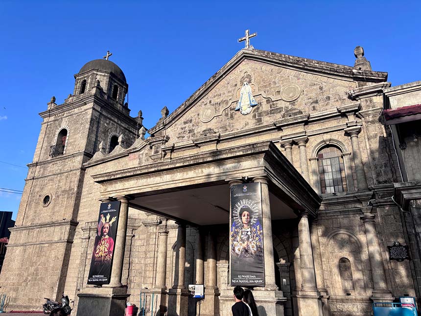 Wide exterior shot of the Minor Basilica and Parish of La Purisima Concepcion showcasing its historic church facade and entrance.
