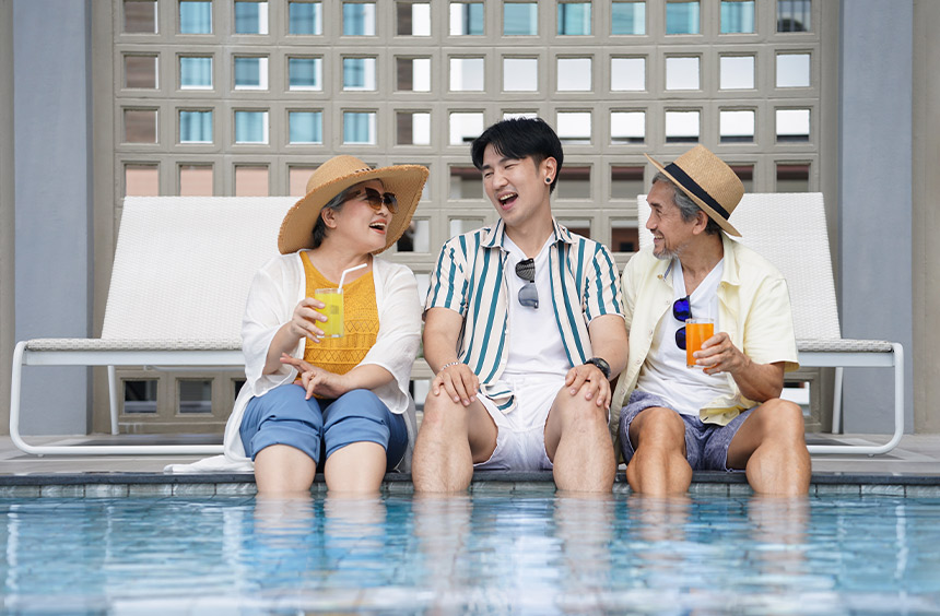 Family relaxing by the pool during a staycation.