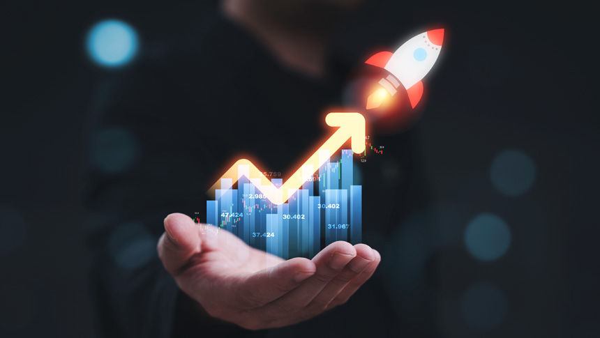 A person holding a holographic growth chart and rocket symbolizing business and financial growth.