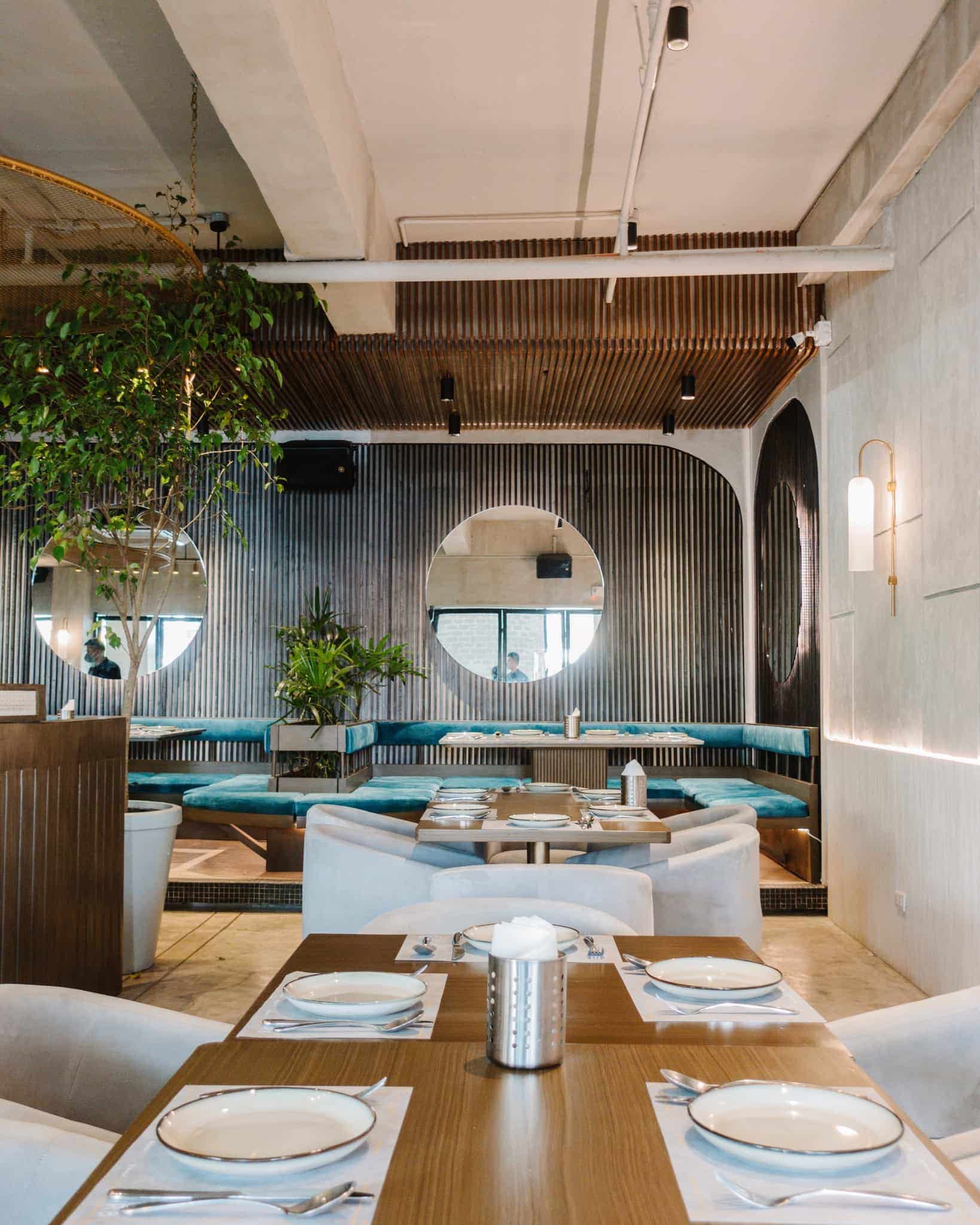 Cur8 interiors with set tables before a service rush