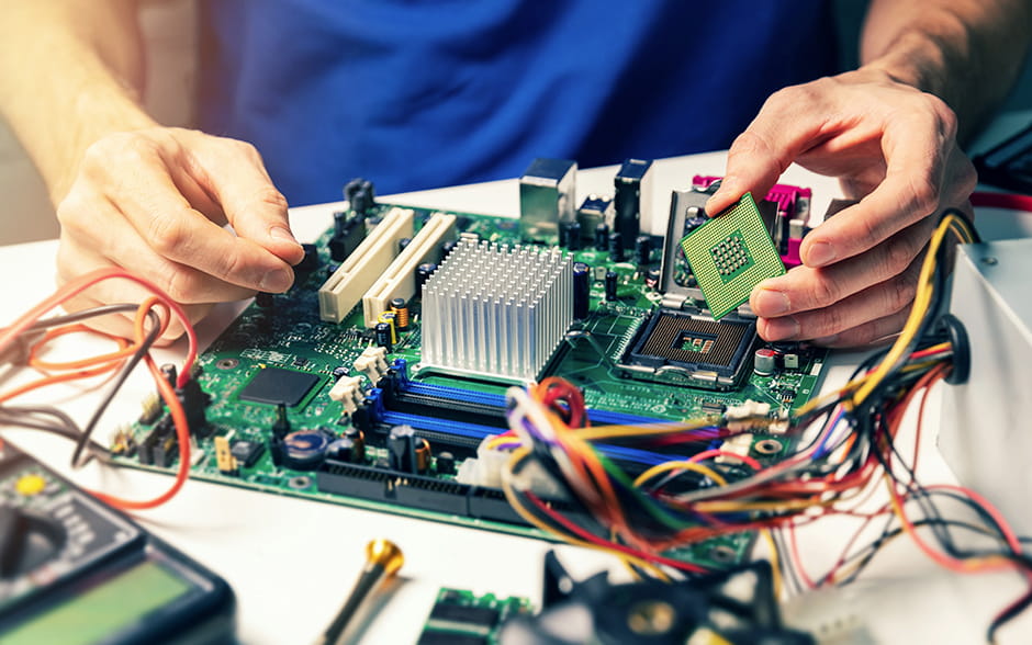 Close-up photo of hands holding a CPU to install it.