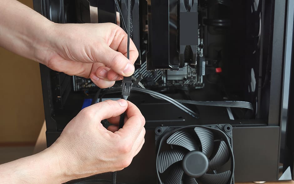 Photo of hands checking the power connector in a fan cooling system unit.