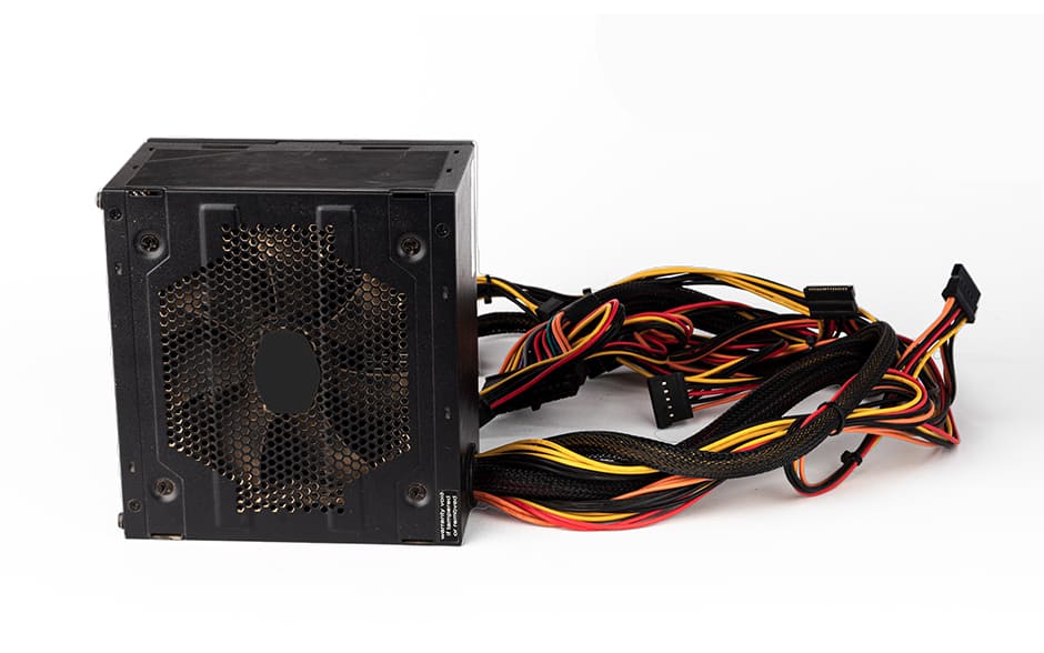 Photo of a computer power supply unit or PSU, front fan side, with wires and cables against a white background.