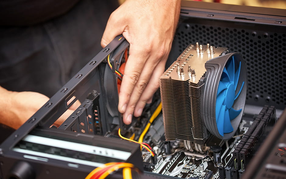 Close-up photo of hands installing the cooling system of a computer.
