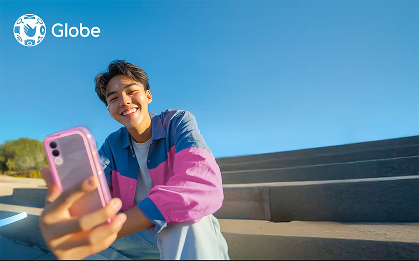 A young man using a smartphone outdoors.