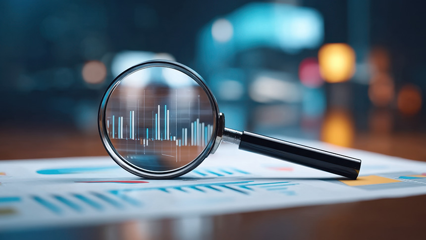A magnifying glass on top of a chart.
