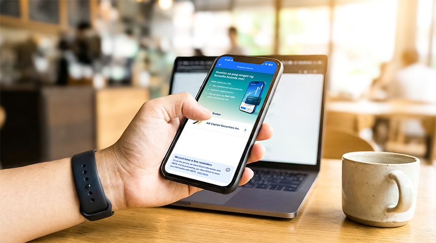 Person using a smartphone to monitor investments and access stock trading tools through a mobile app.