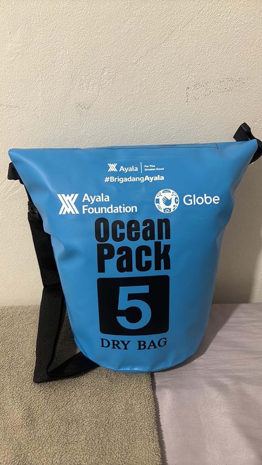 A Globe and Ayala Foundation disaster response dry bag used for earthquake recovery aid.