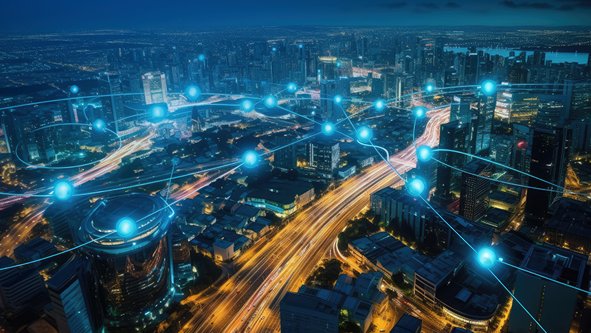 Aerial night city skyline connected by glowing blue dedicated internet network lines and nodes.