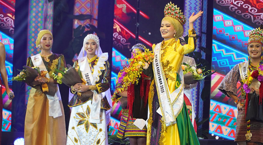 Hiyas sa Kadayawan candidate in indigenous attire dancing on stage with dancers holding bamboos